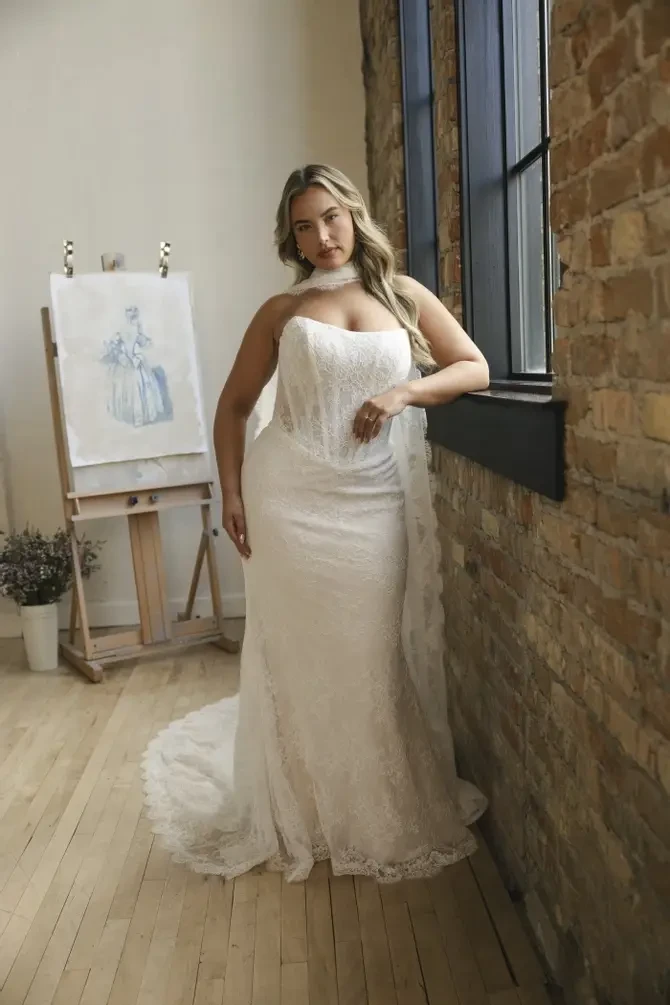 model is wearing a strapless sheath bridal gown