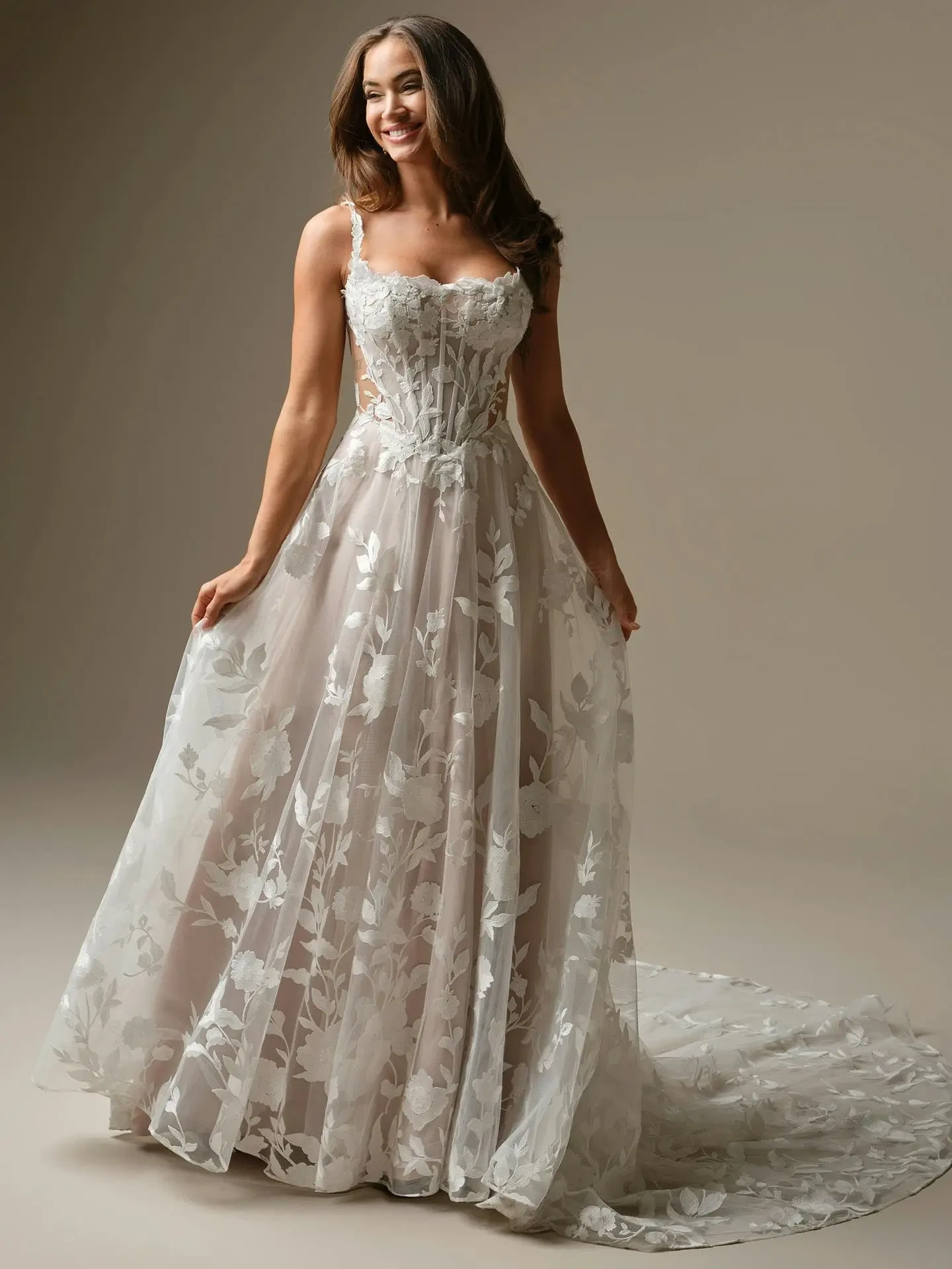 model is wearing a flowy a-line bridal gown
